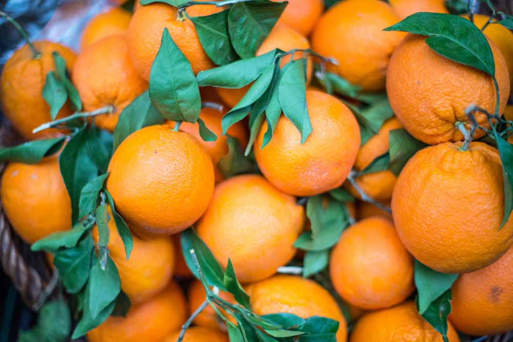 Oranges with green leaves at Borough Market, London