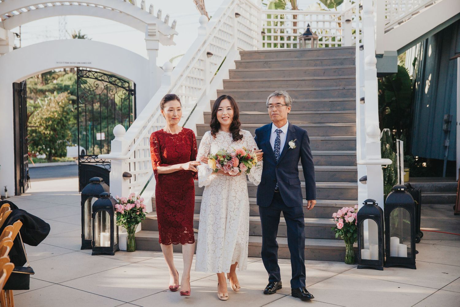 bride entering ceremony with her parents