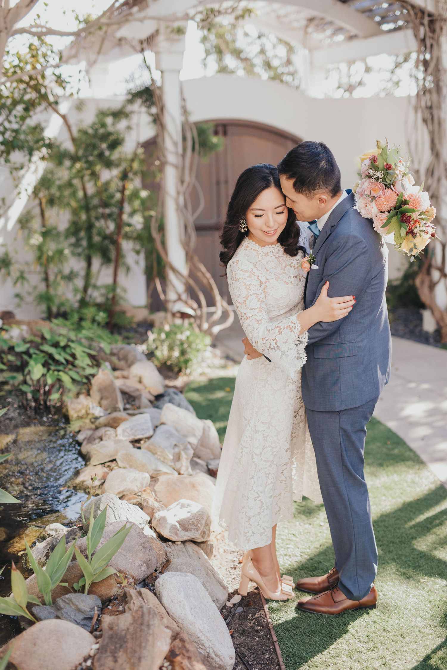 bride & groom near pond at verandas manhattan beach