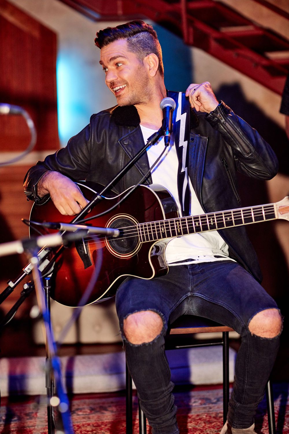 Andy Grammer preforming a song, playing his guitar in an intimate setting at Only In Nashville. Photo by Joel Alexander