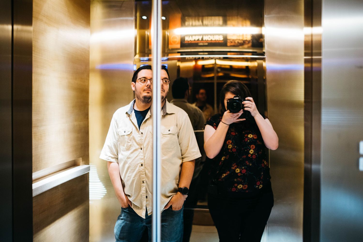 Taylor Moore of Taylor Moore Portraiture with her boyfriend in an elevator in Kuala Lumpur