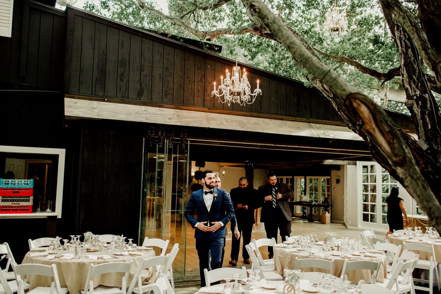 groomsmen walking out getting ready for pictures near reception area