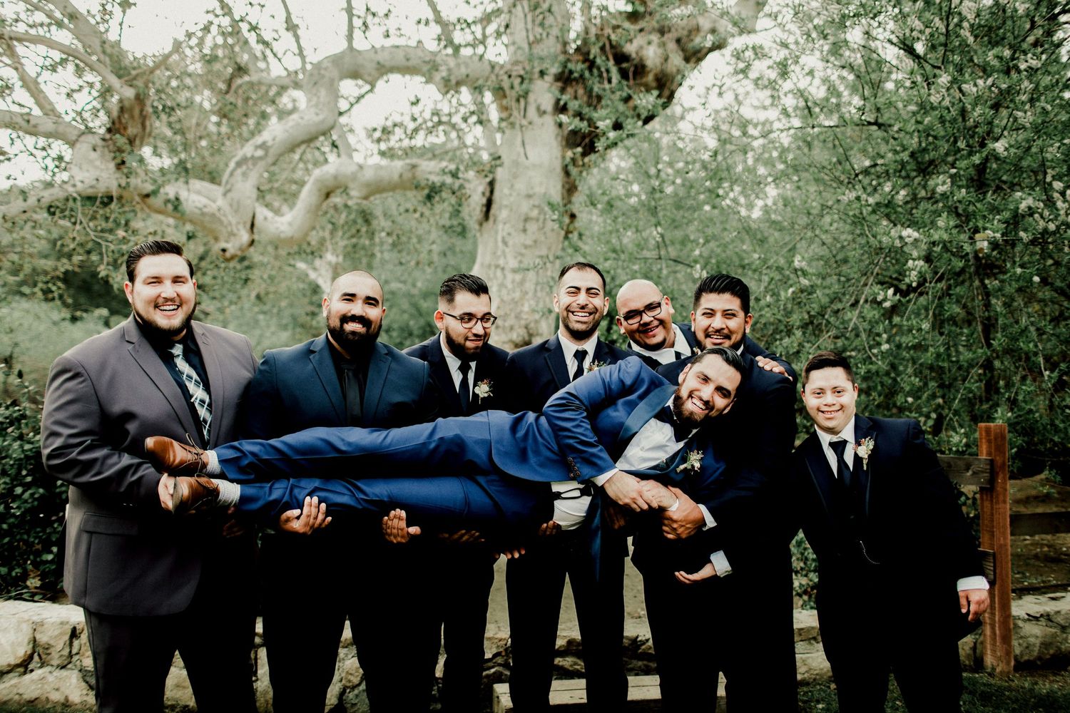 groomsmen carrying groom at calamigos ranch