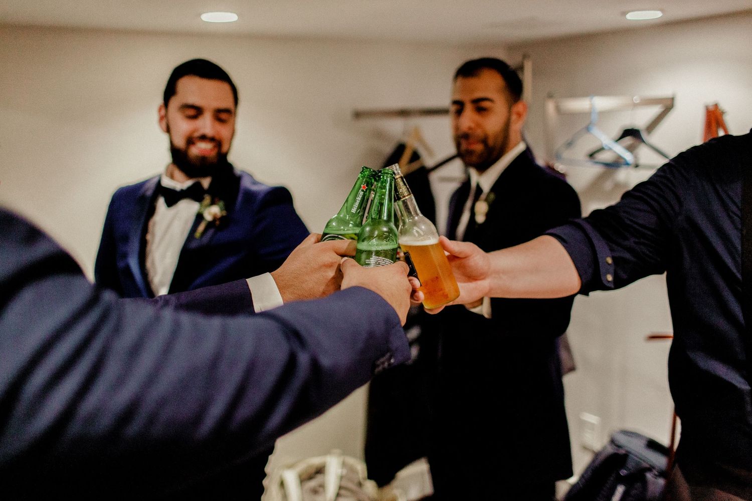 groomsmen cheering beers before wedding ceremony