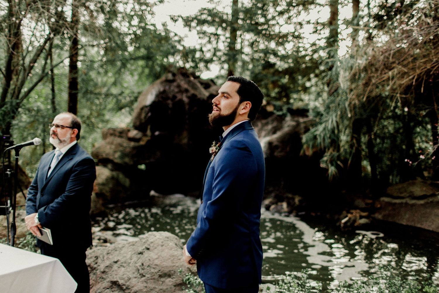 groom standing at altar with pastor waiting for bride