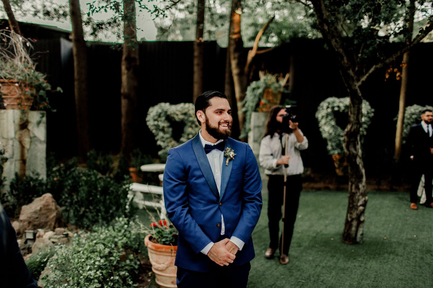 groom smiling seeing bride for the first time in wedding dress