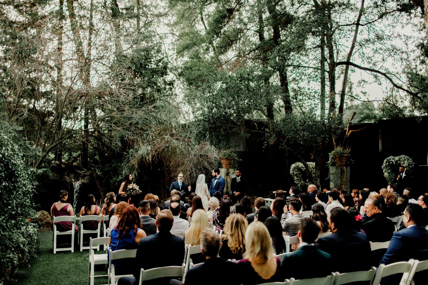 bride and groom standing at altar with wedding guests