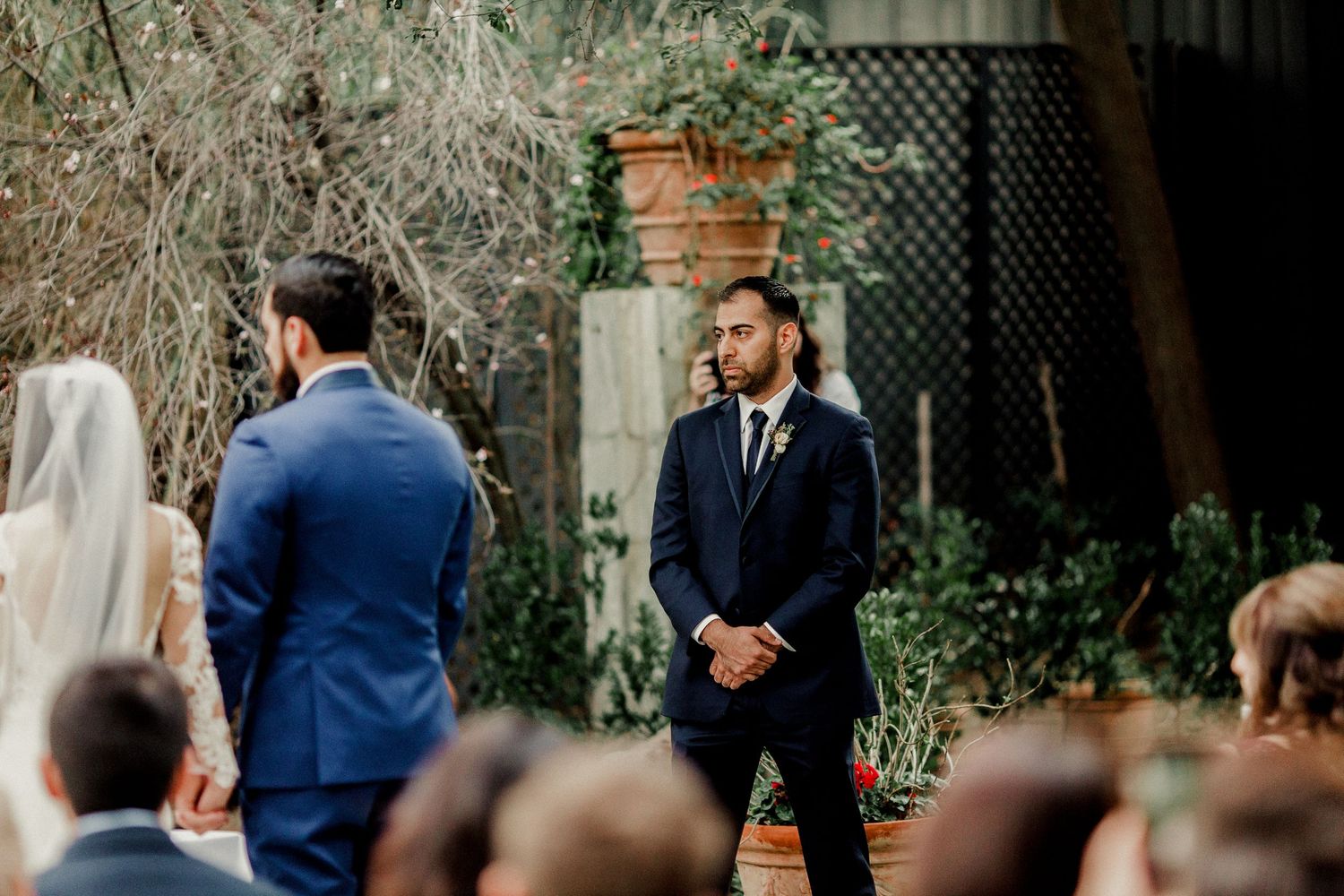best man standing at altar with bride and groom