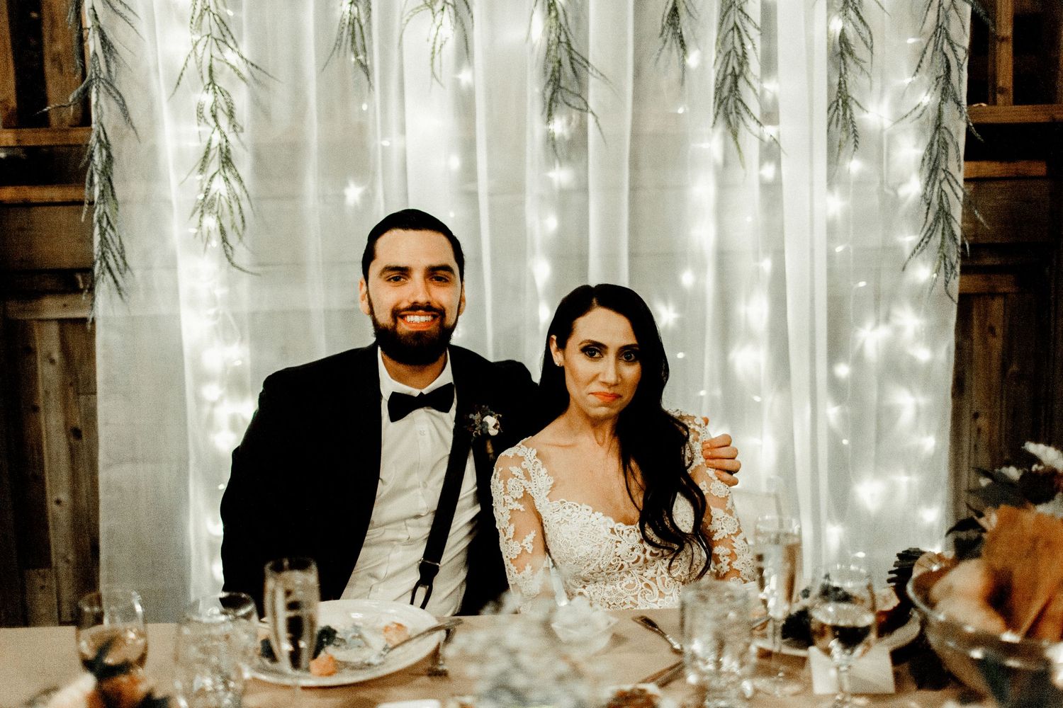 bride and groom sitting at sweetheart table