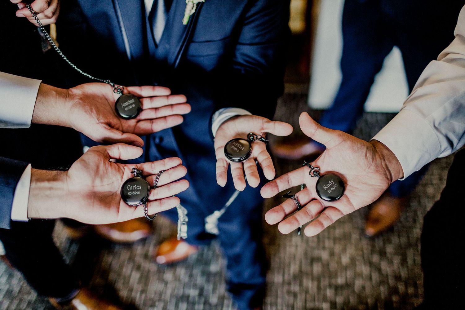 shot of custom pocket watch with groomsmen engravings