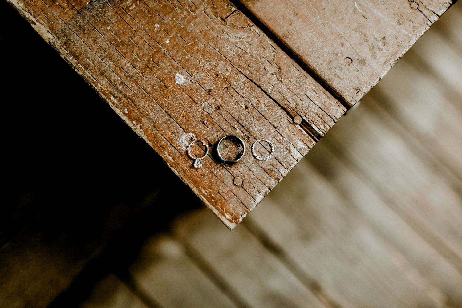 detailed image of wedding bands on a wooden bench at calamigos ranch