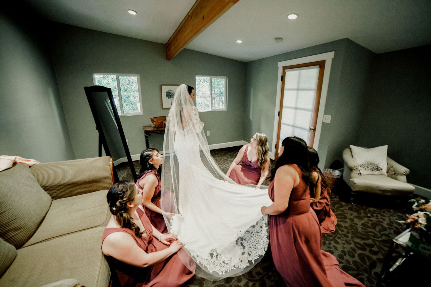 bridal party helping bride with dress