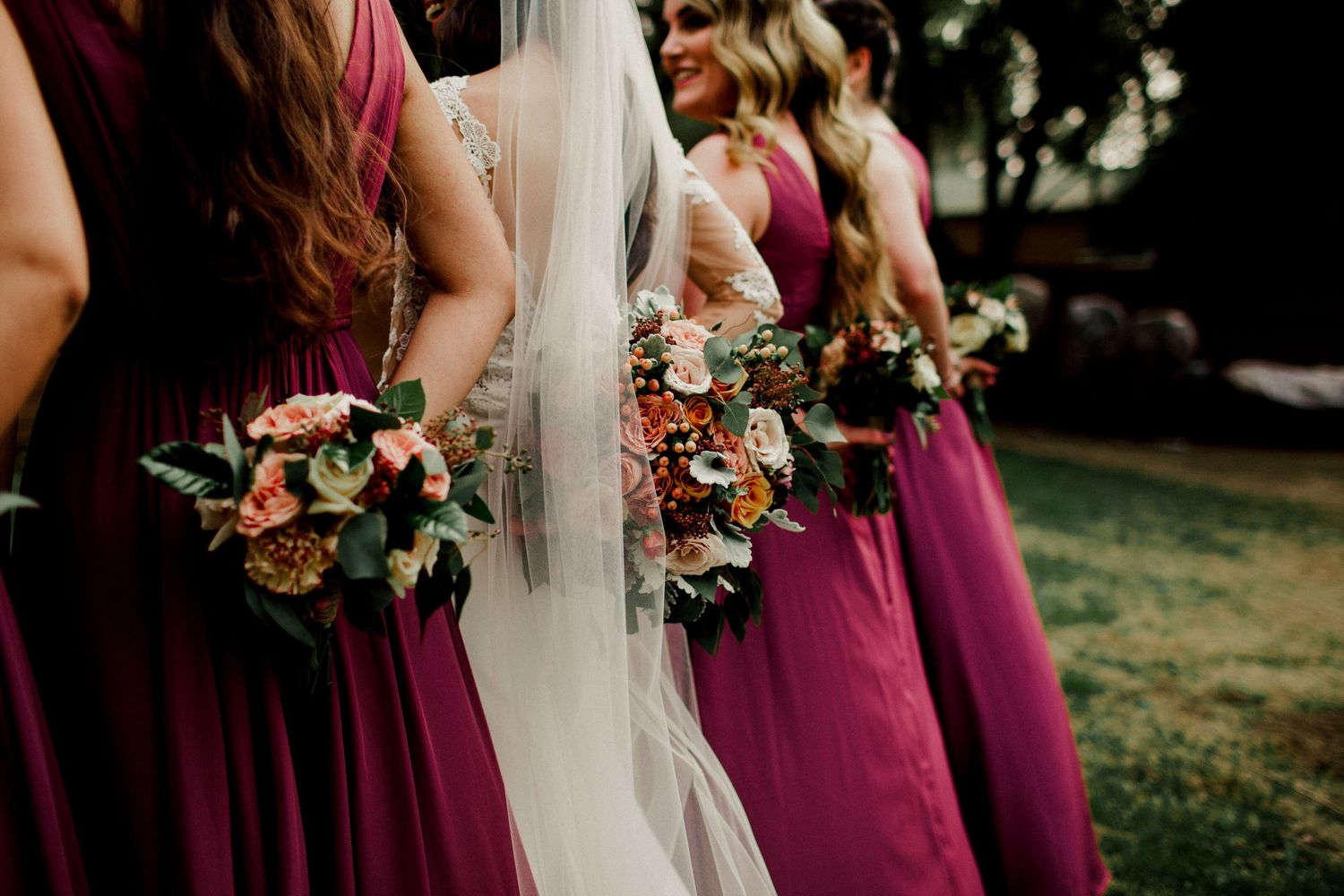 bridal party holding bouquet's behind back
