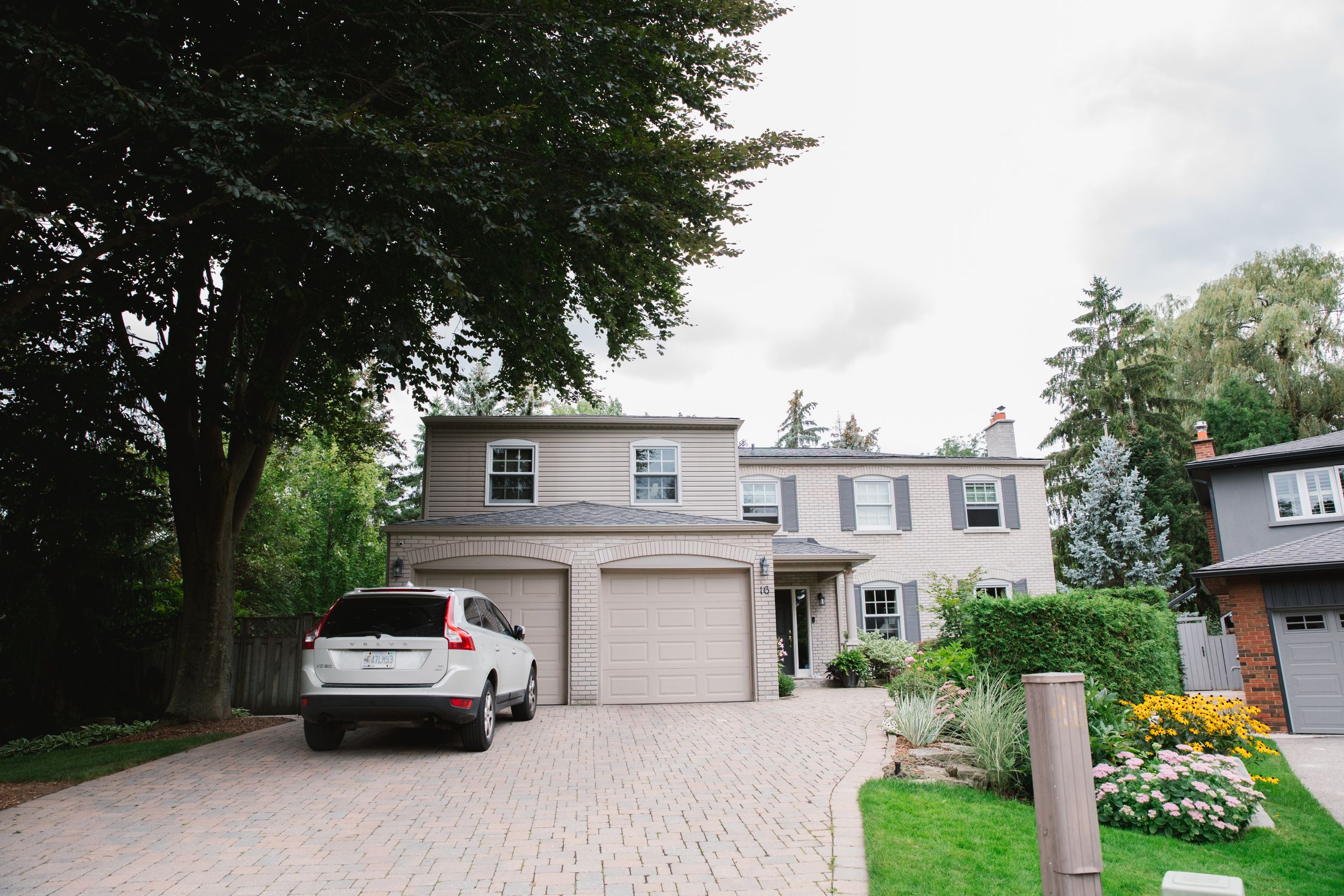 residential grey house with green yard