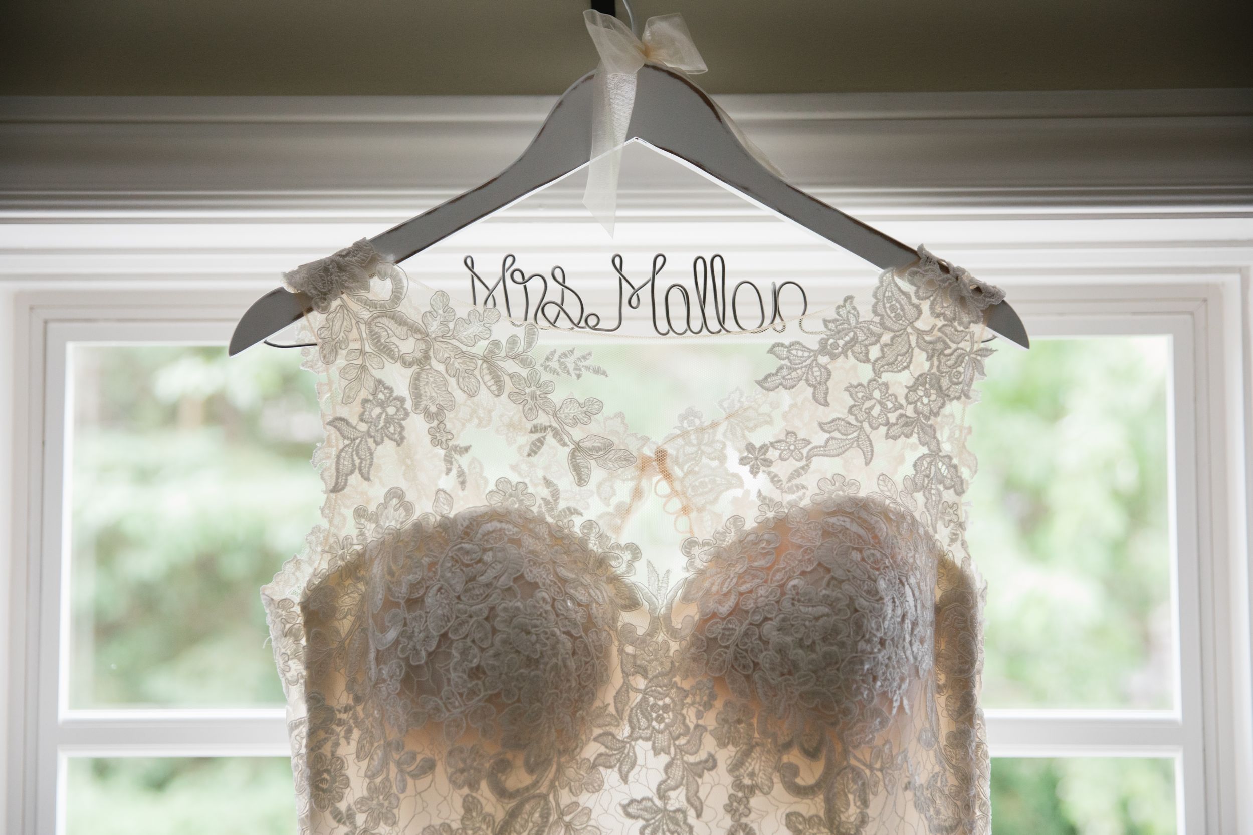 close up of wedding dress hung on custom bridal hanger