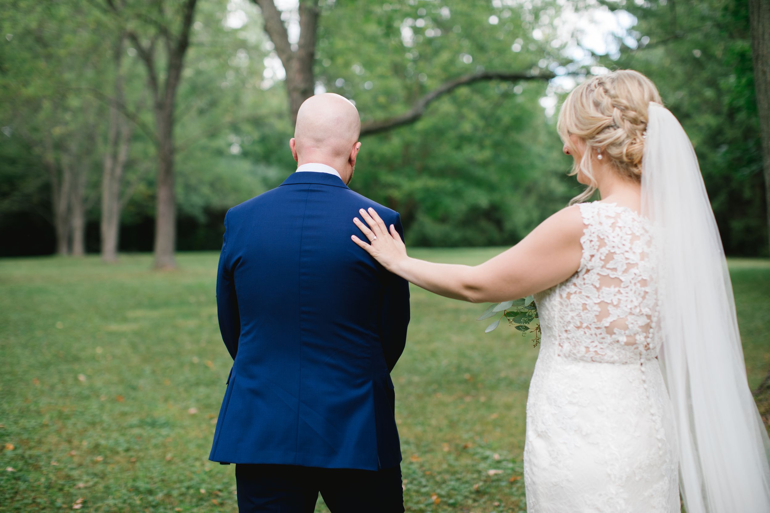 bride tapping groom on the shoulder from behind in toronto
