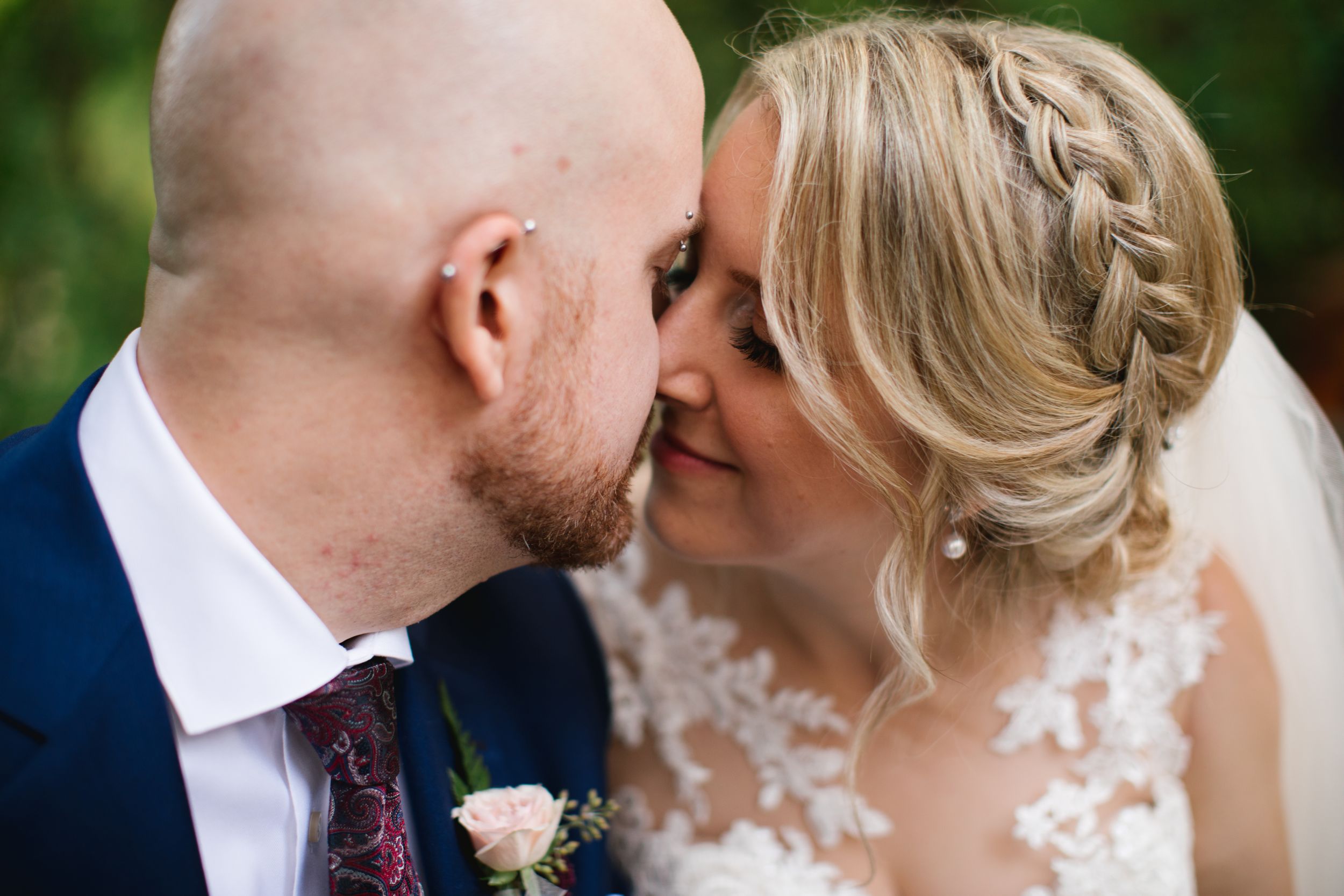 close up of bride and groom kissing wedding hairstyle braid greenery in toronto