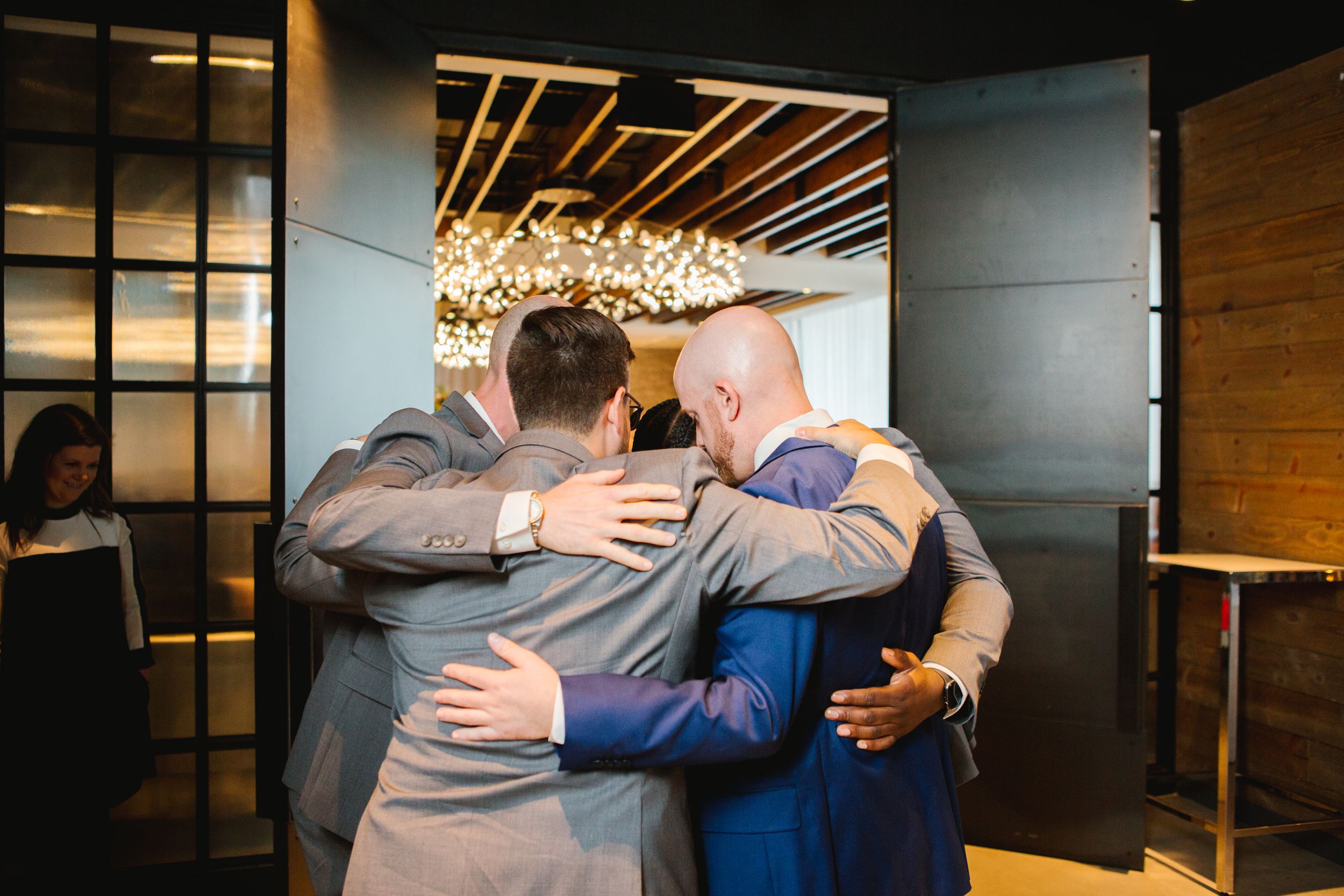 groom group hugging groomsmen before ceremony