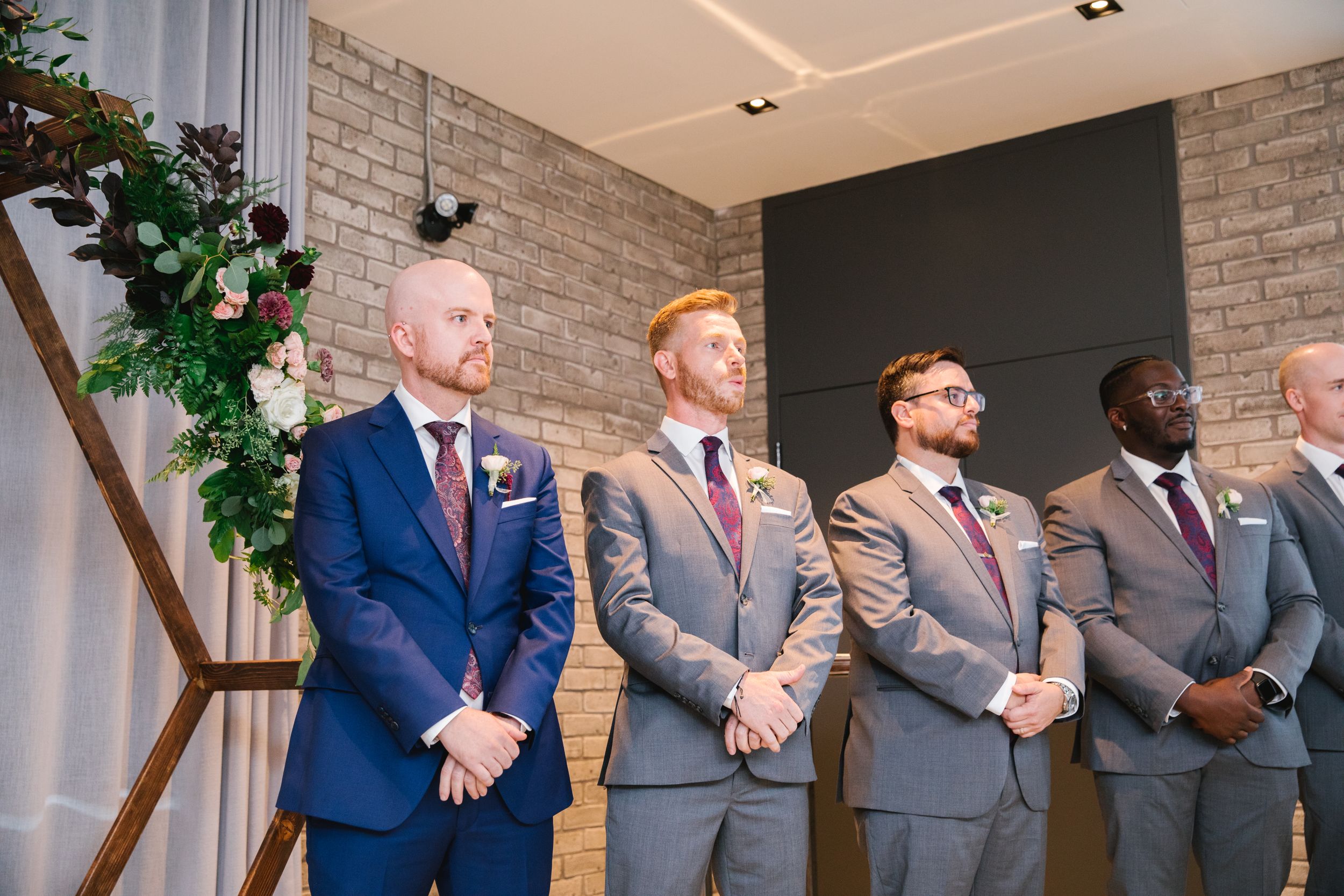 groom waiting for bride to walk down the aisle with his groomsmen