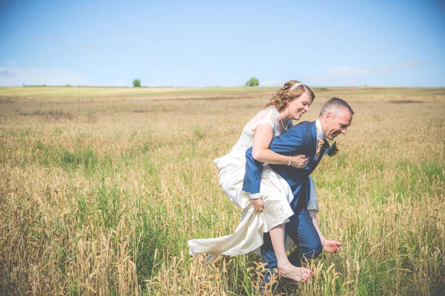 Groom running away with his bride on back