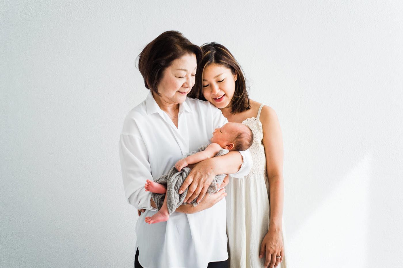 Family portrait of grandma mum and newborn