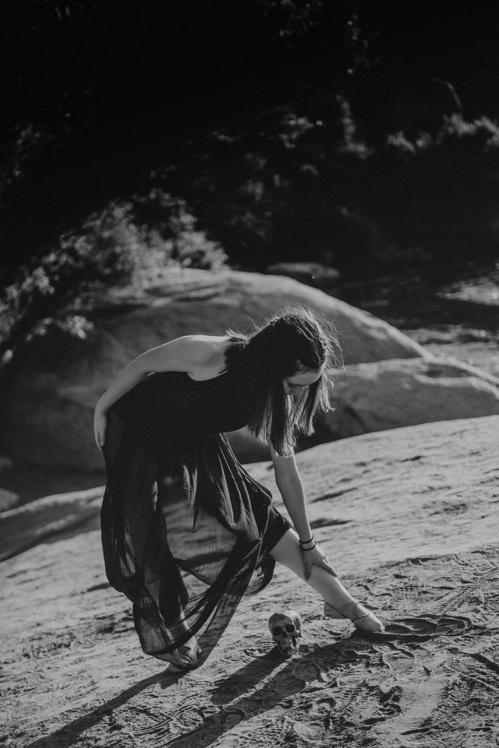 Girl dancing next to a skull for a Halloween photoshoot in Three Rivers