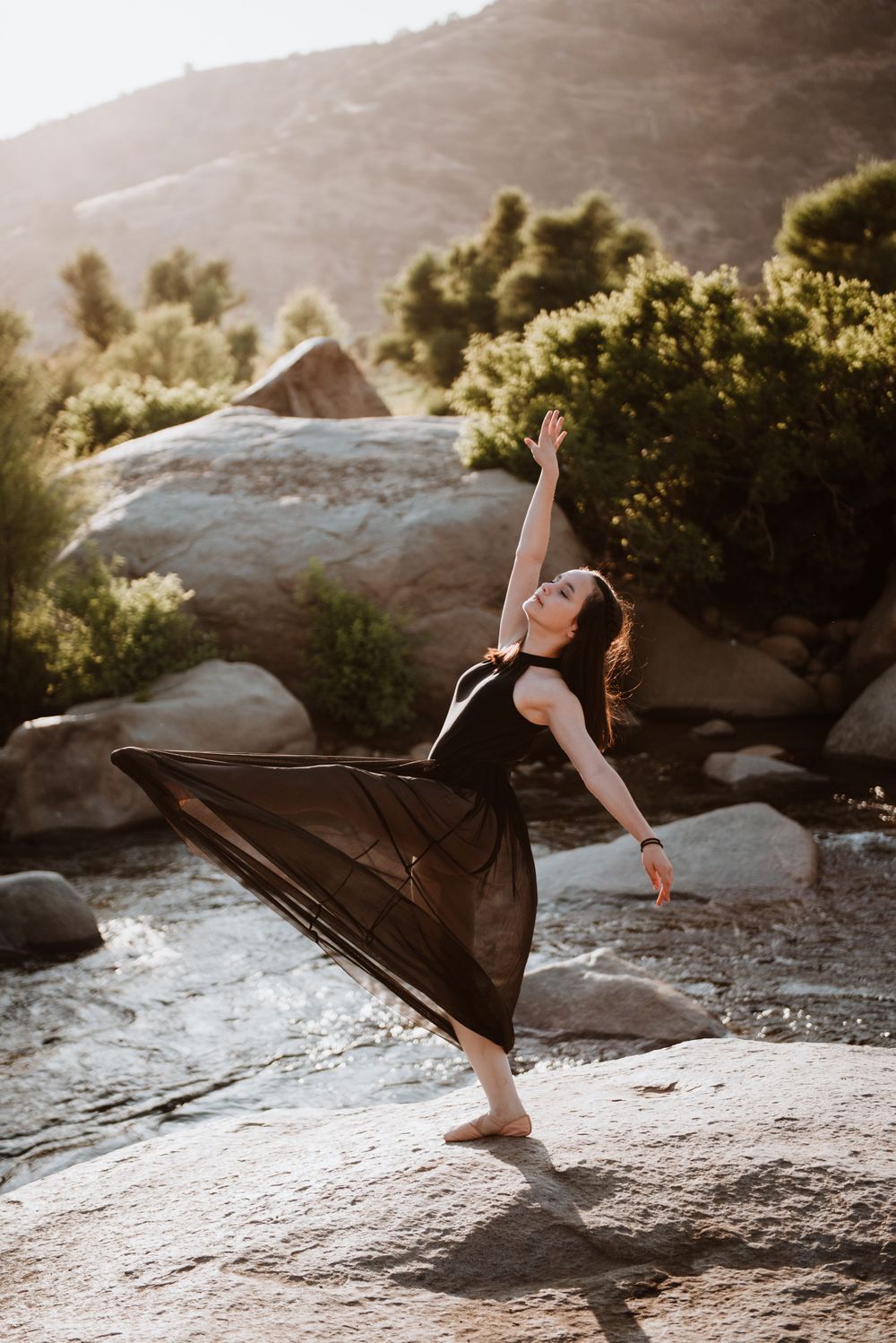 Girl dancing in front of a river during a Halloween photoshoot in Three Rivers, California