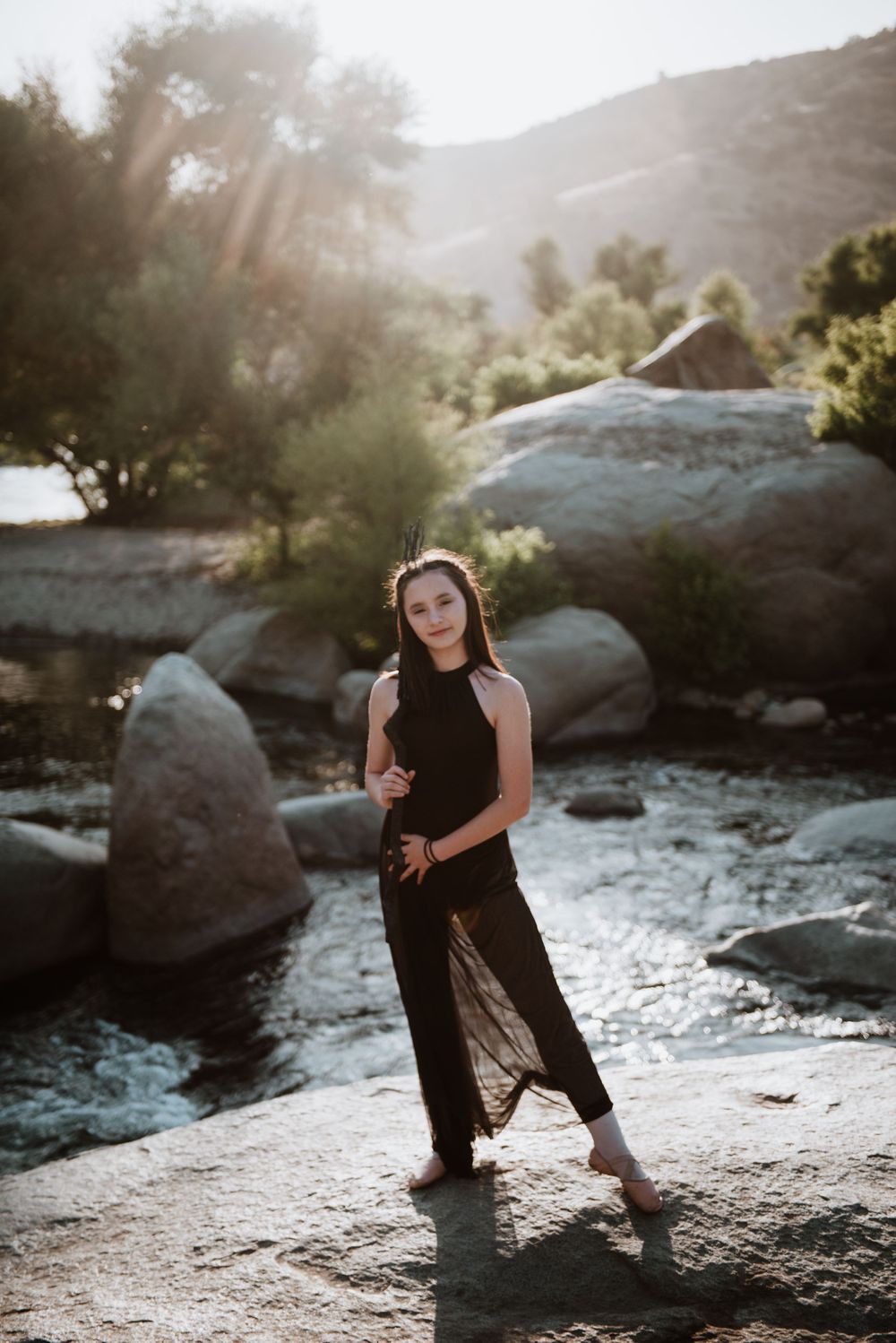 Girl posing with a broom in front of the river; Halloween photoshoot in Three Rivers, California