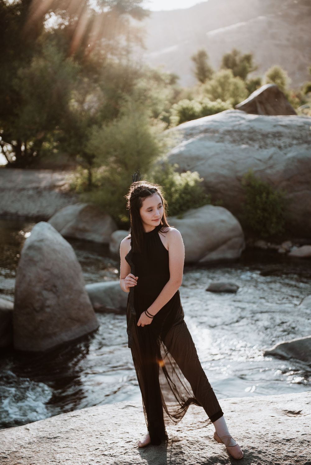 Girl posing with a broom in front of the river; Halloween photoshoot in Three Rivers, California
