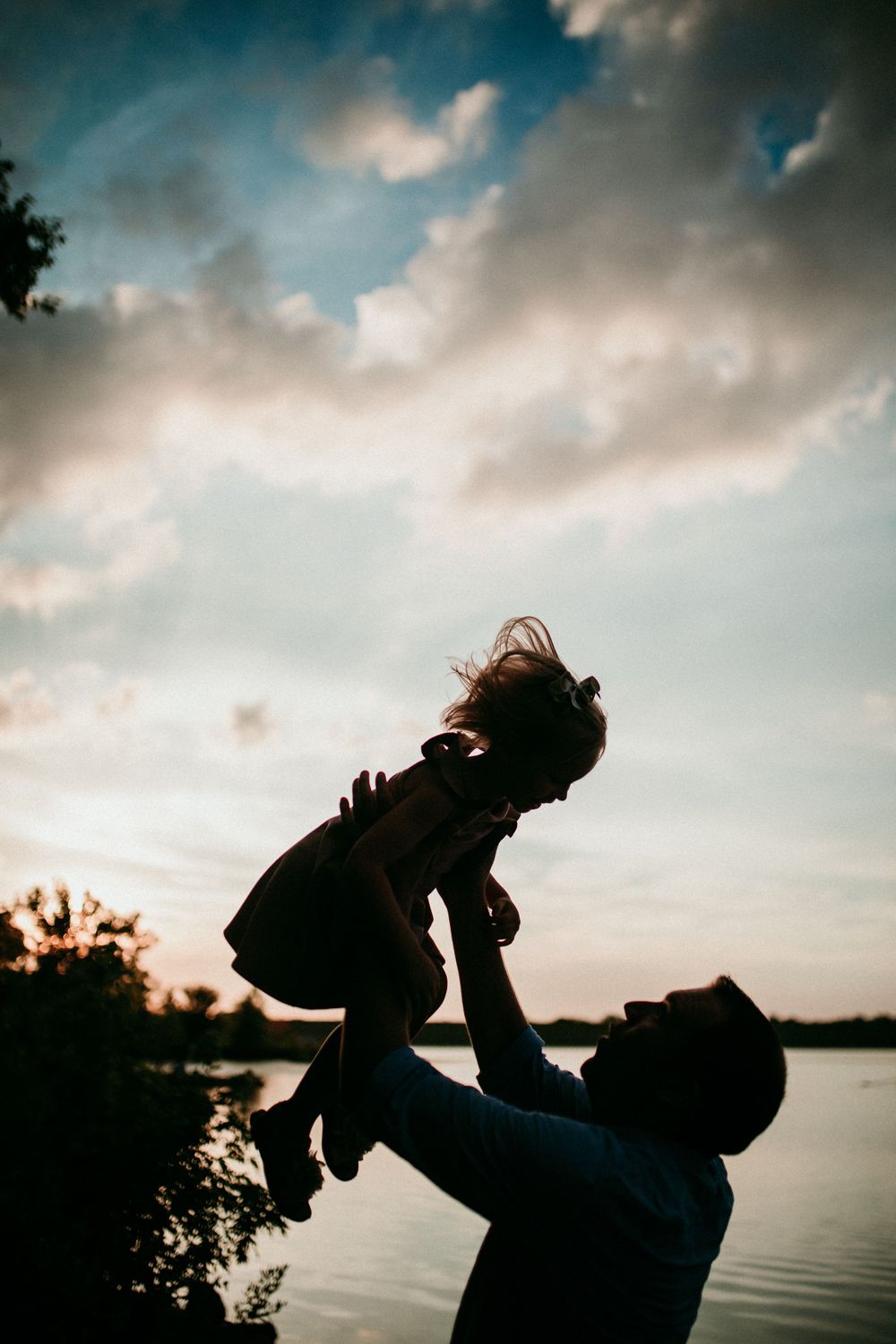 father lifting his daughter