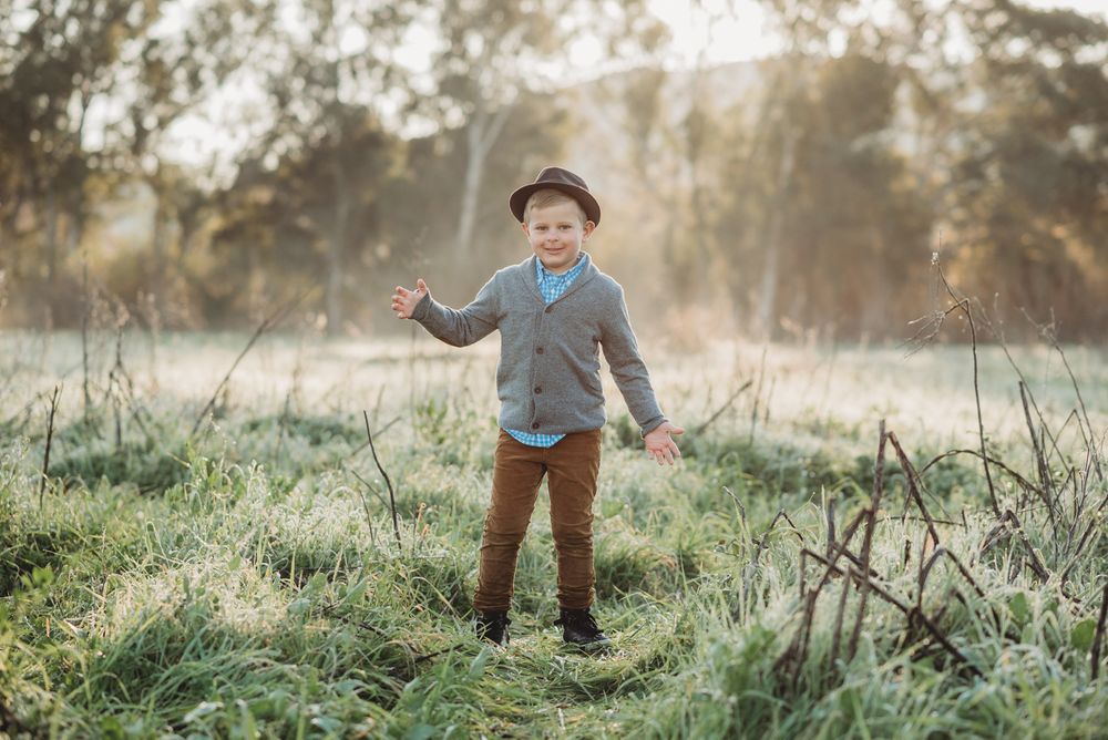 Boy happy standing at sunrise