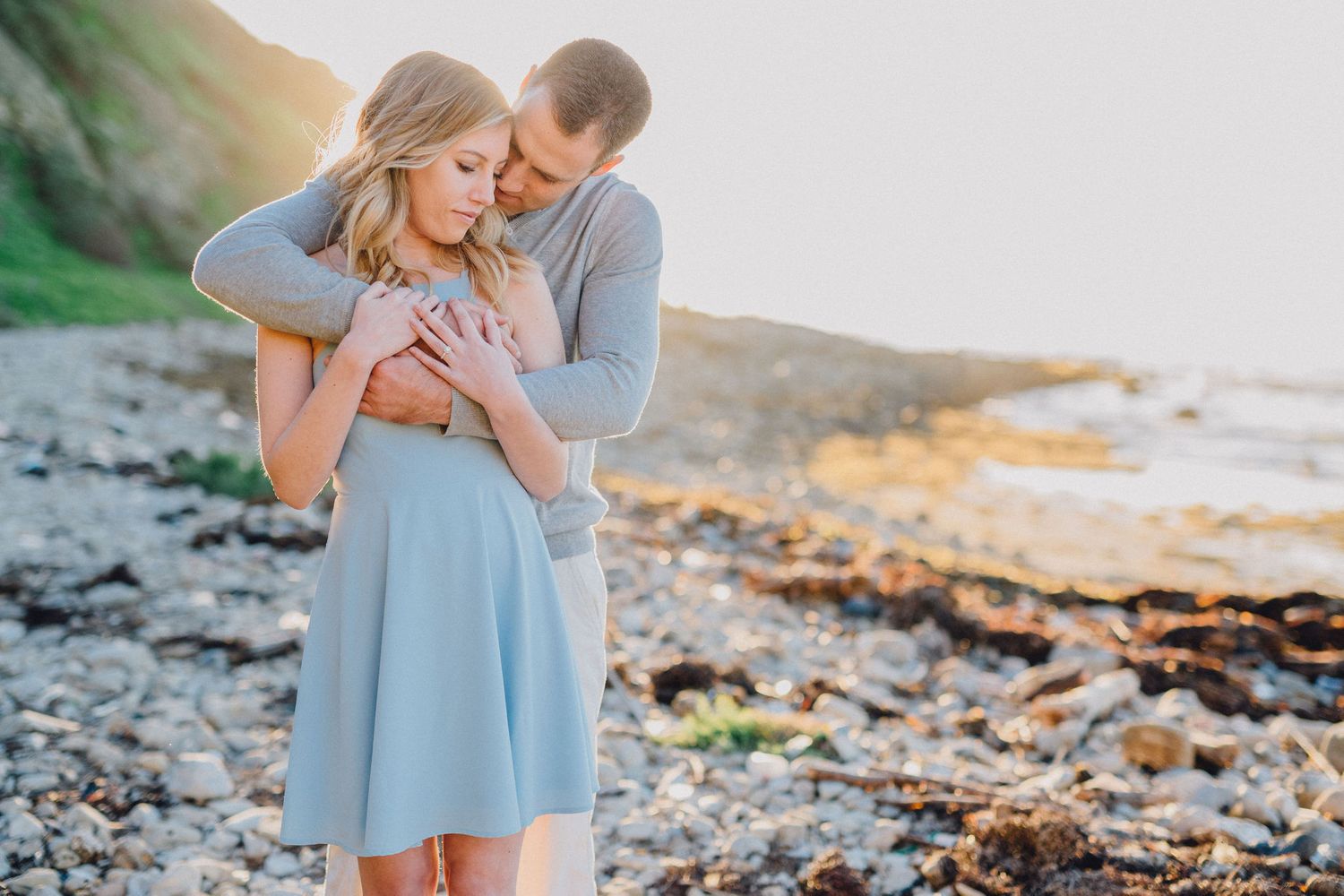 hug on beach engagement photo