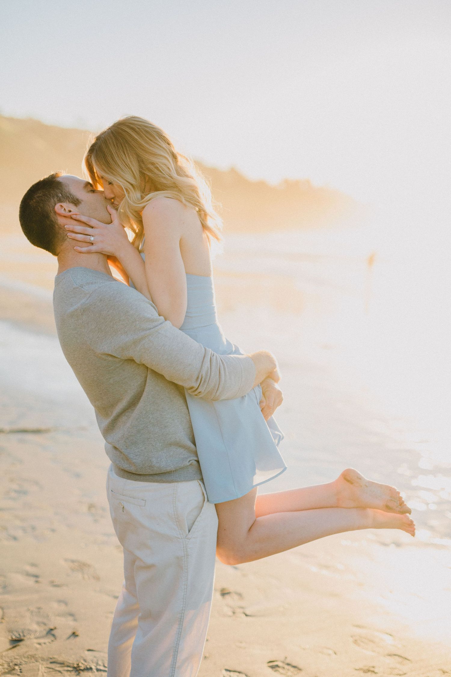lifting kiss engagement photo