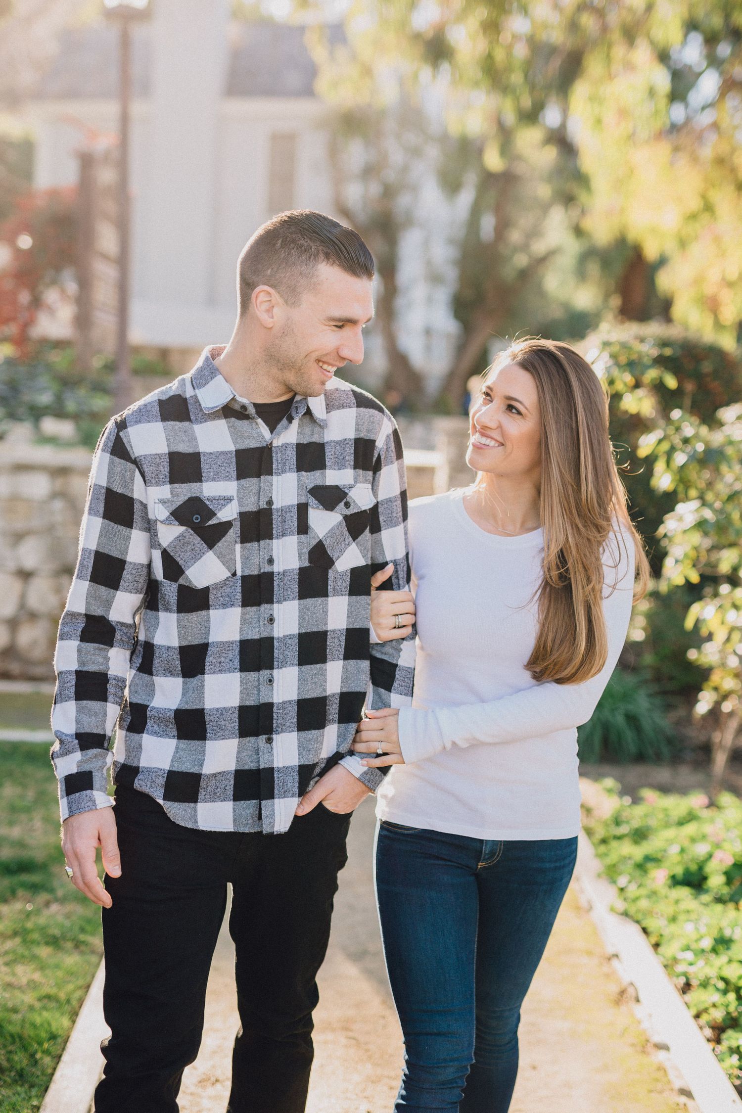 engaged couple walking down garden path