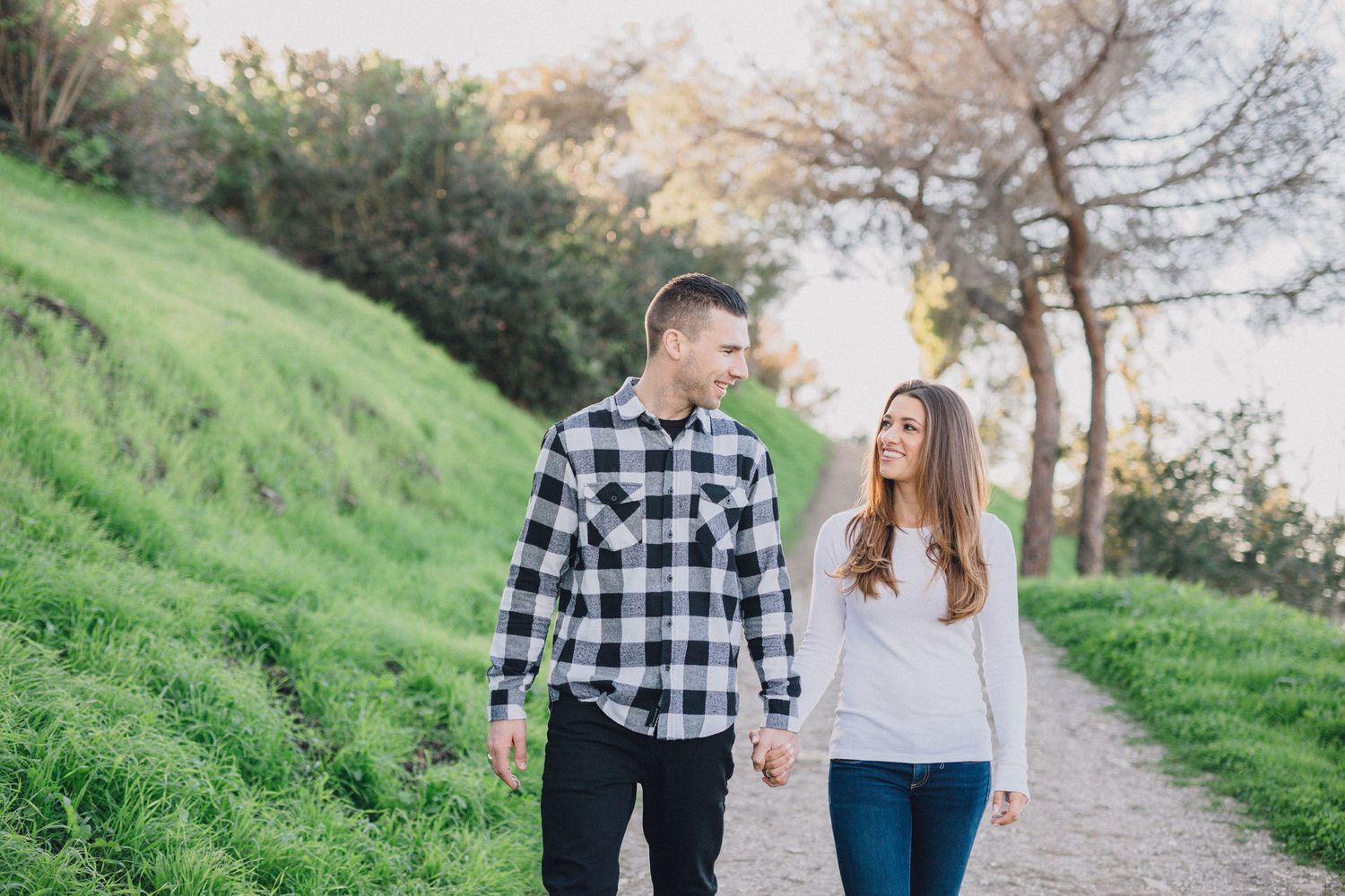 engaged couple walking on rustic trail in palos verdes