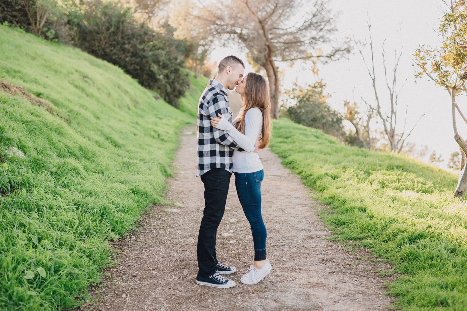 couple kissing on rustic trail