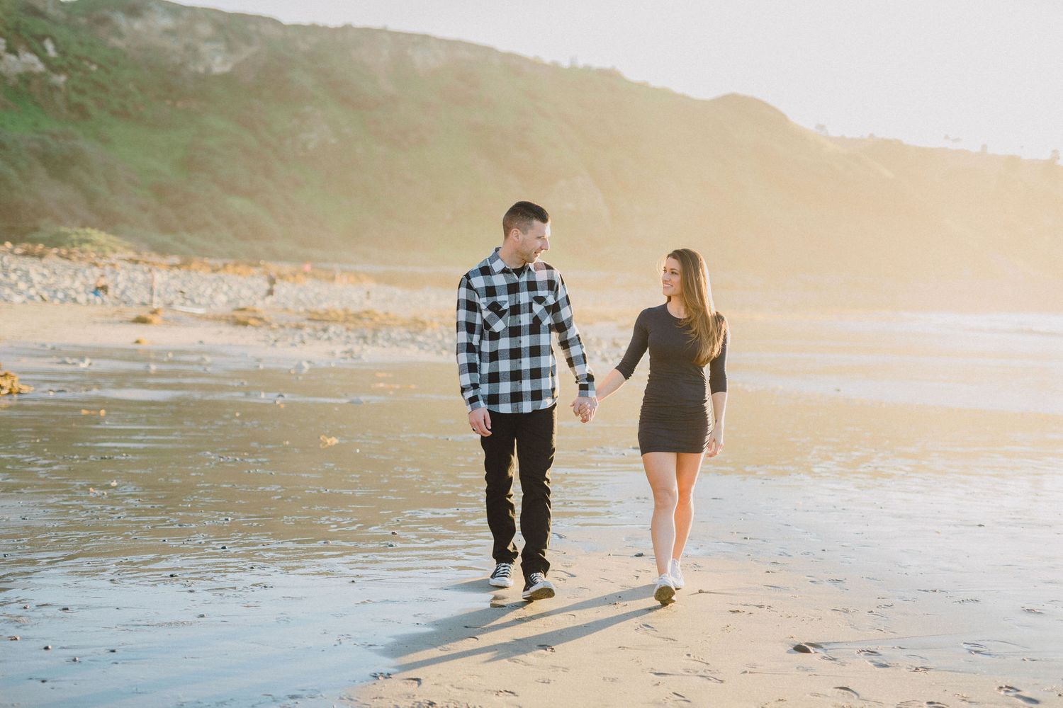engaged couple walking on the beach in palos verdes