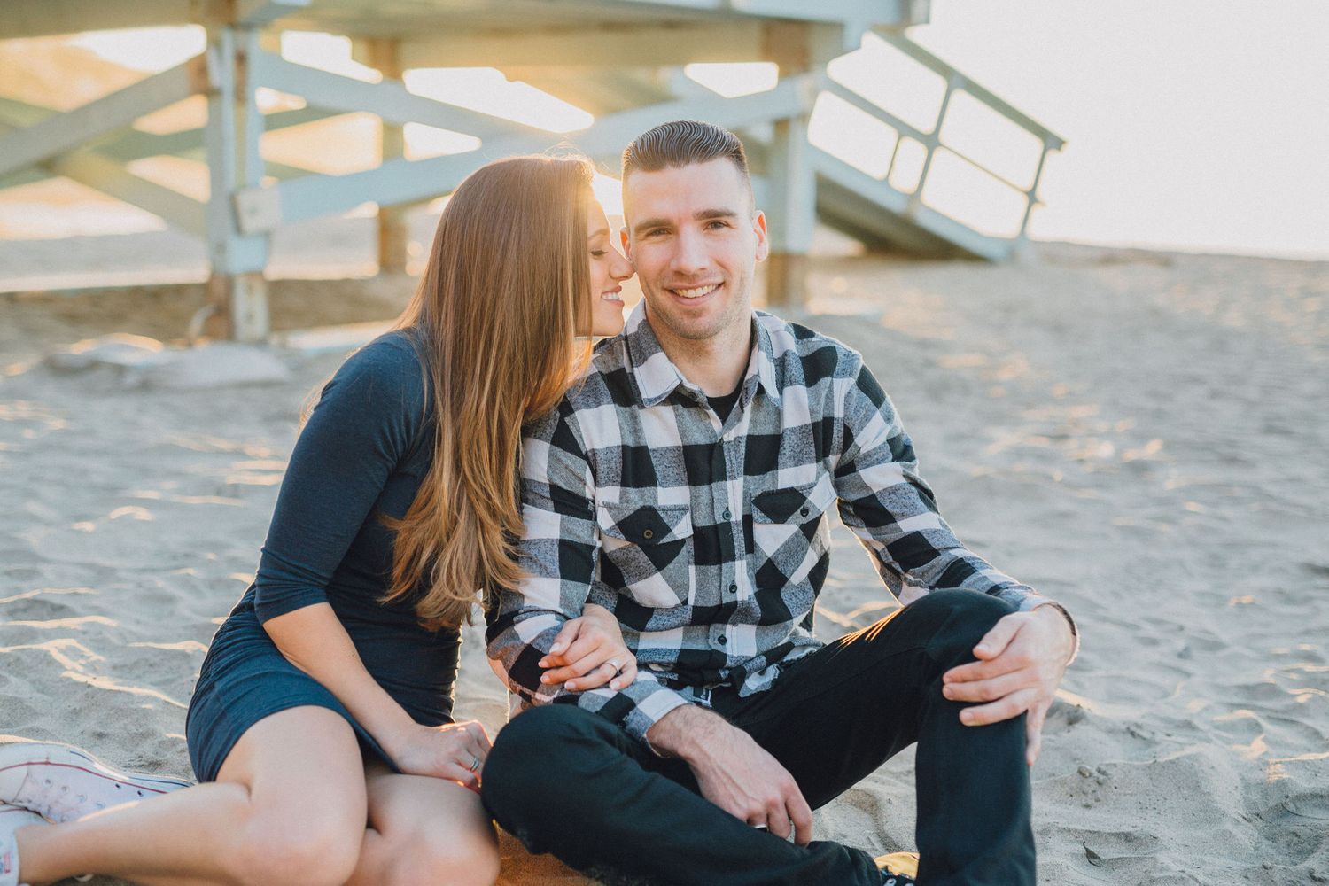 lifeguard tower engagement photo at sunset