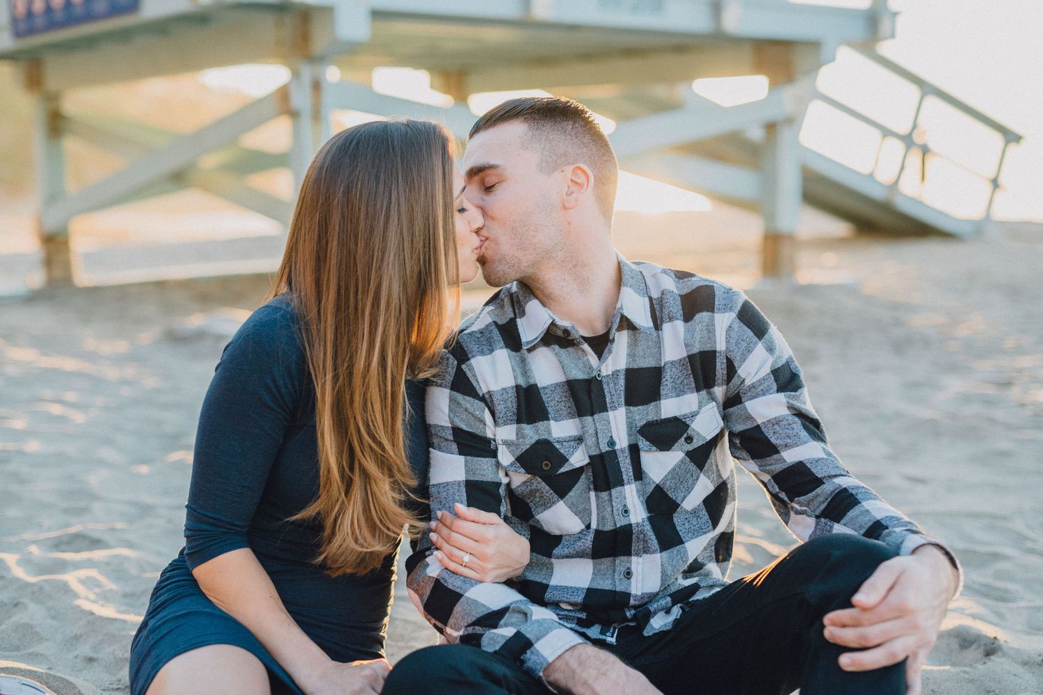 engaged couple kiss in front of lifeguard tower in palos verdes