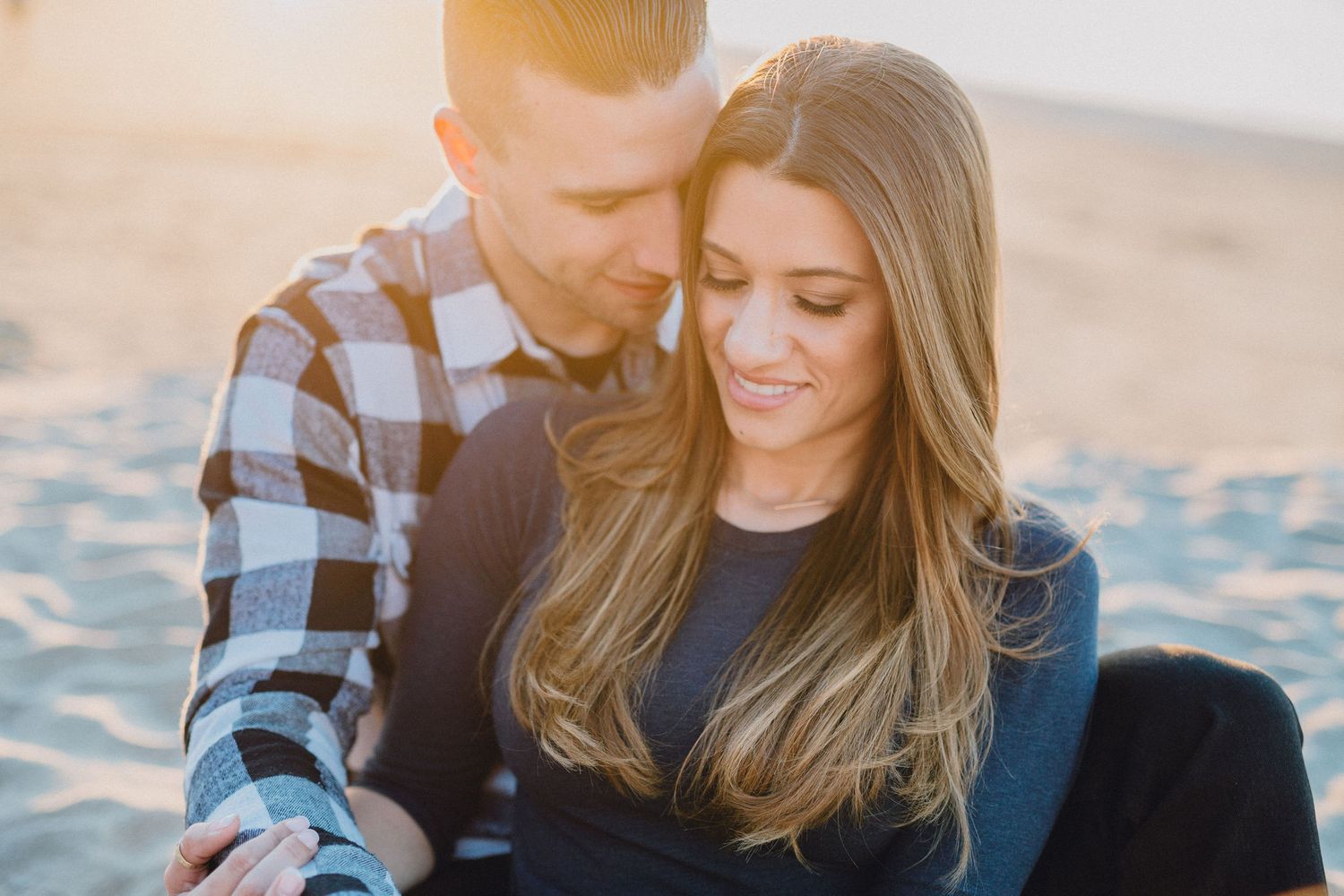backlit engagement photo at beach