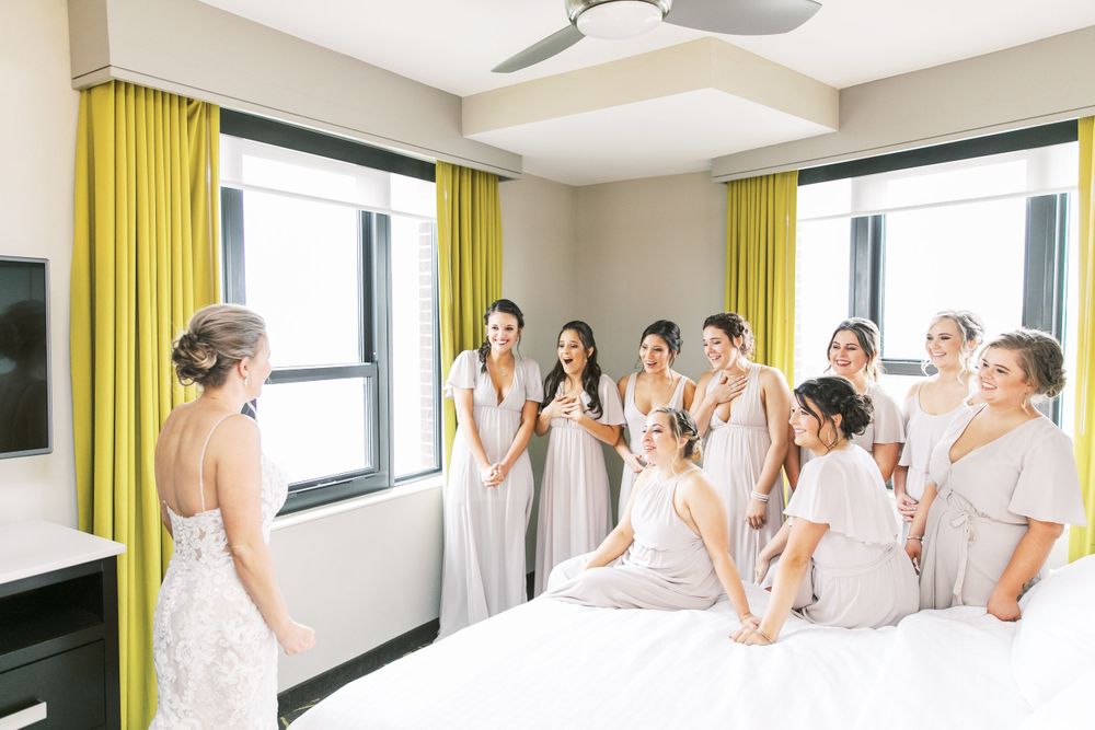 bride does a first look with bridesmaids in the homewood suites in downtown savannah, ga