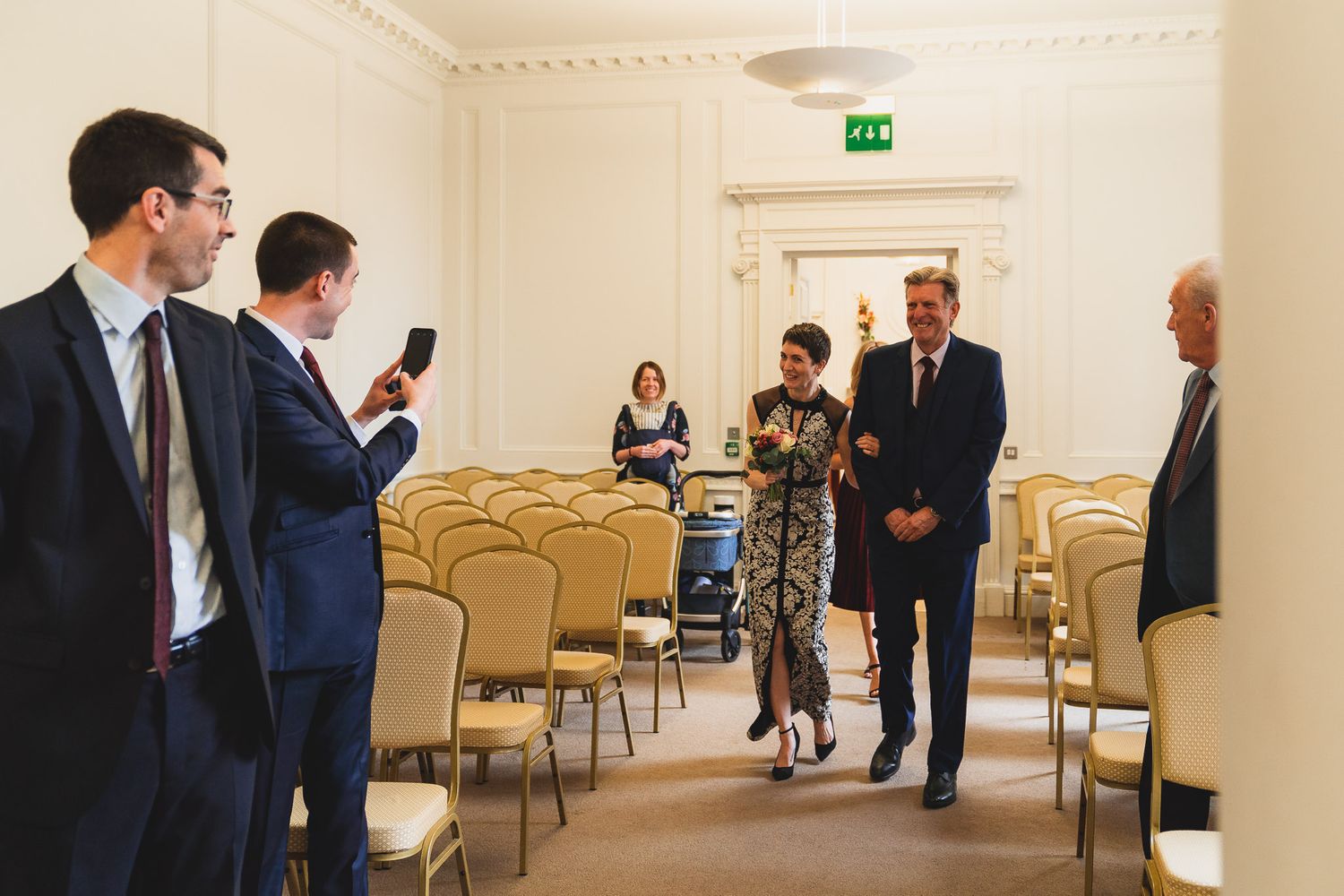 Bride and groom lock eyes as she walks up the aisle in Salisbury Registry Office.
