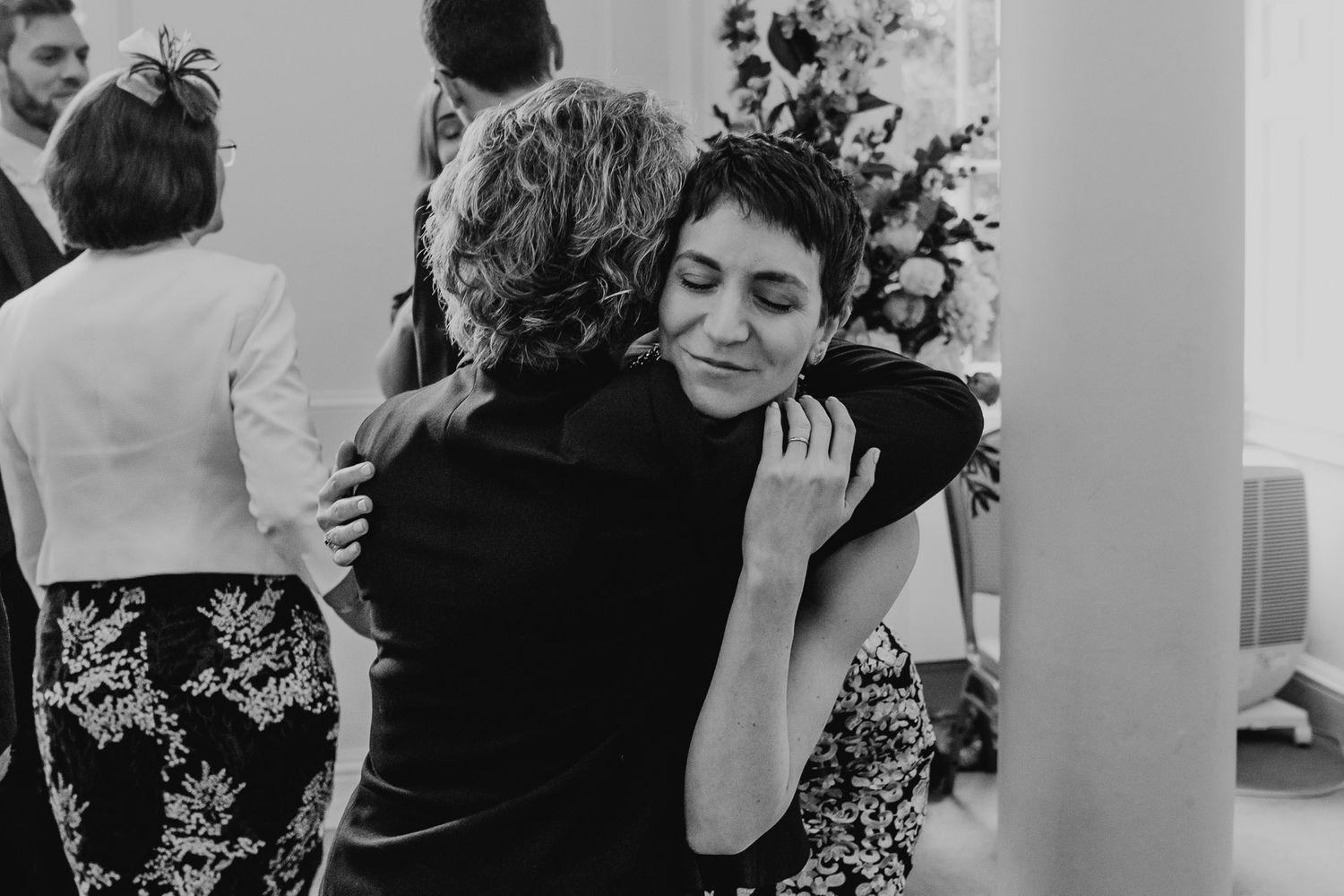 Black and white photo of bride hugging her aunt after the ceremony in Salisbury Registry Office.