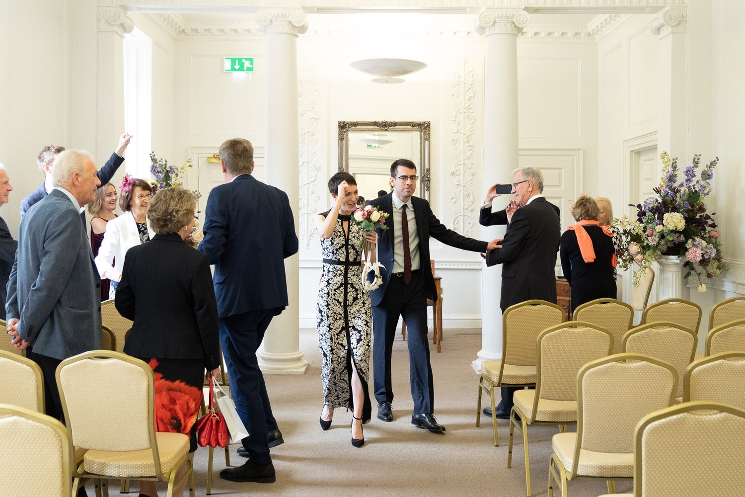 Bride and groom are cheered out of their ceremony room by family at Salisbury Registry Office.