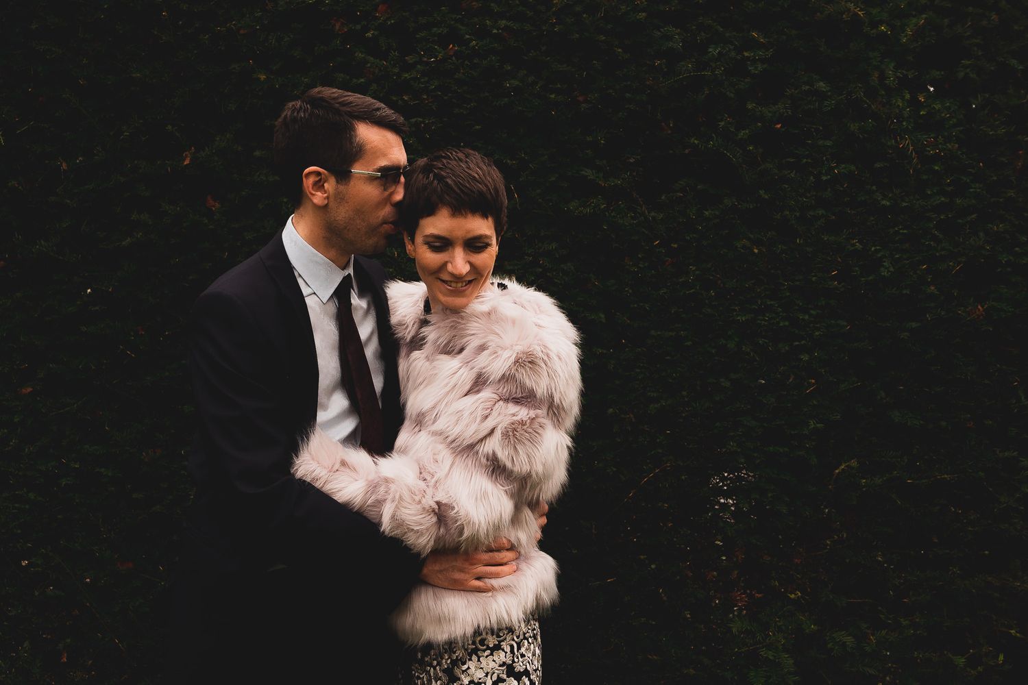 Bride and groom snuggling in the gardens of 10 Castle Street, country house wedding venue in Dorset.