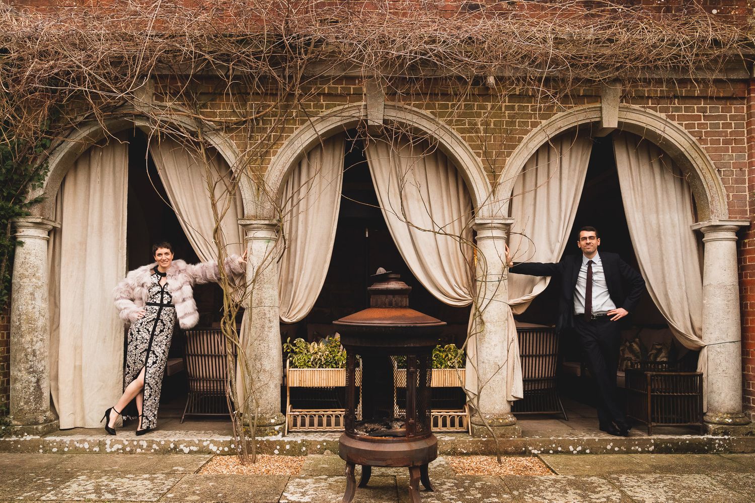 Newlywed bride and groom pose in a series of arches.