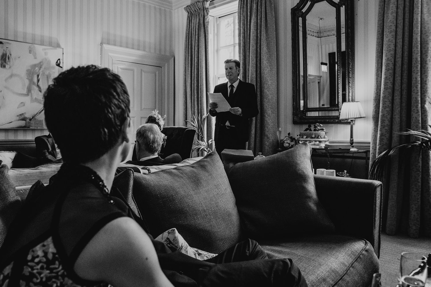 Bride looks on as her father gives his wedding speech.