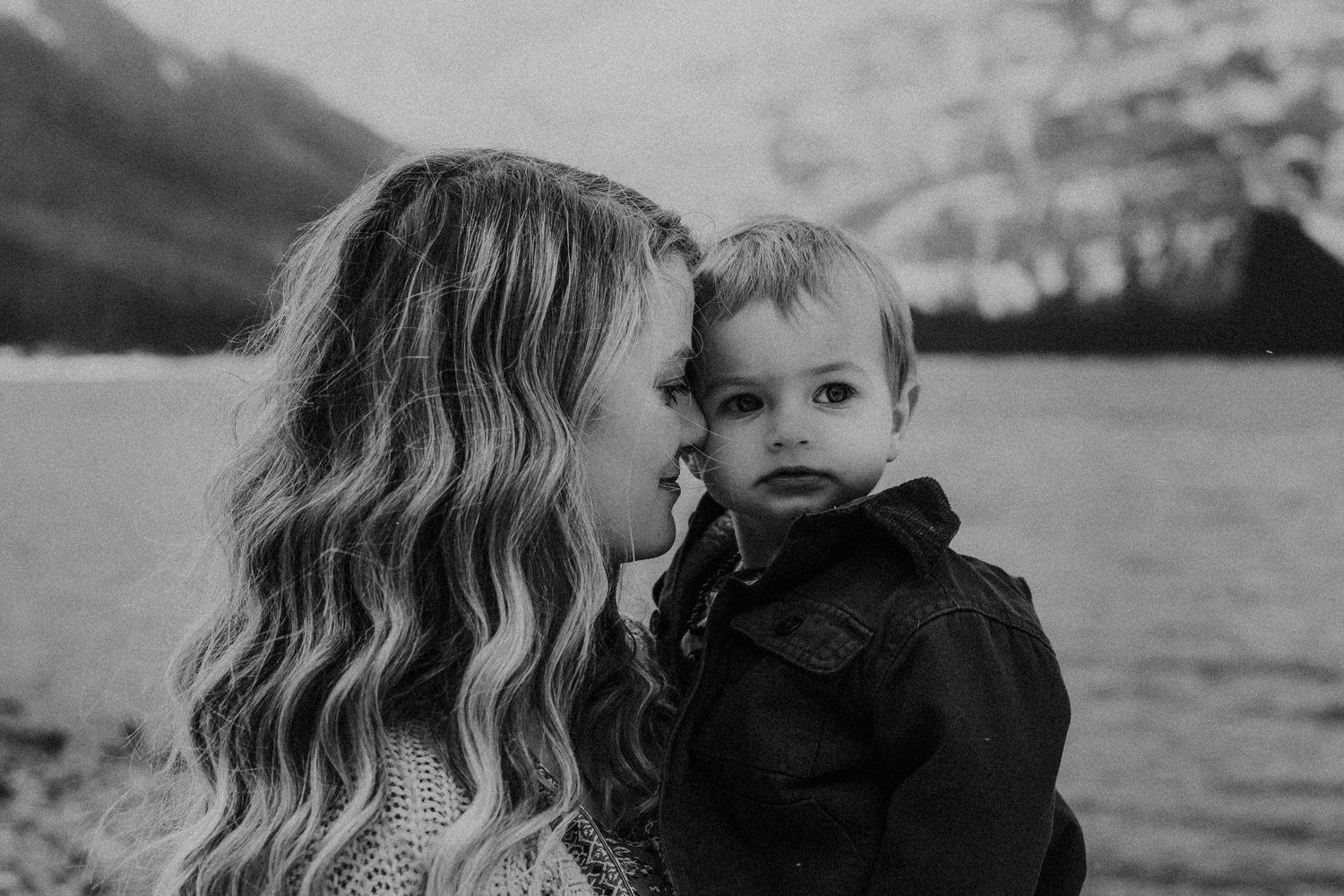 black and white photo of mom and baby boy cuddling