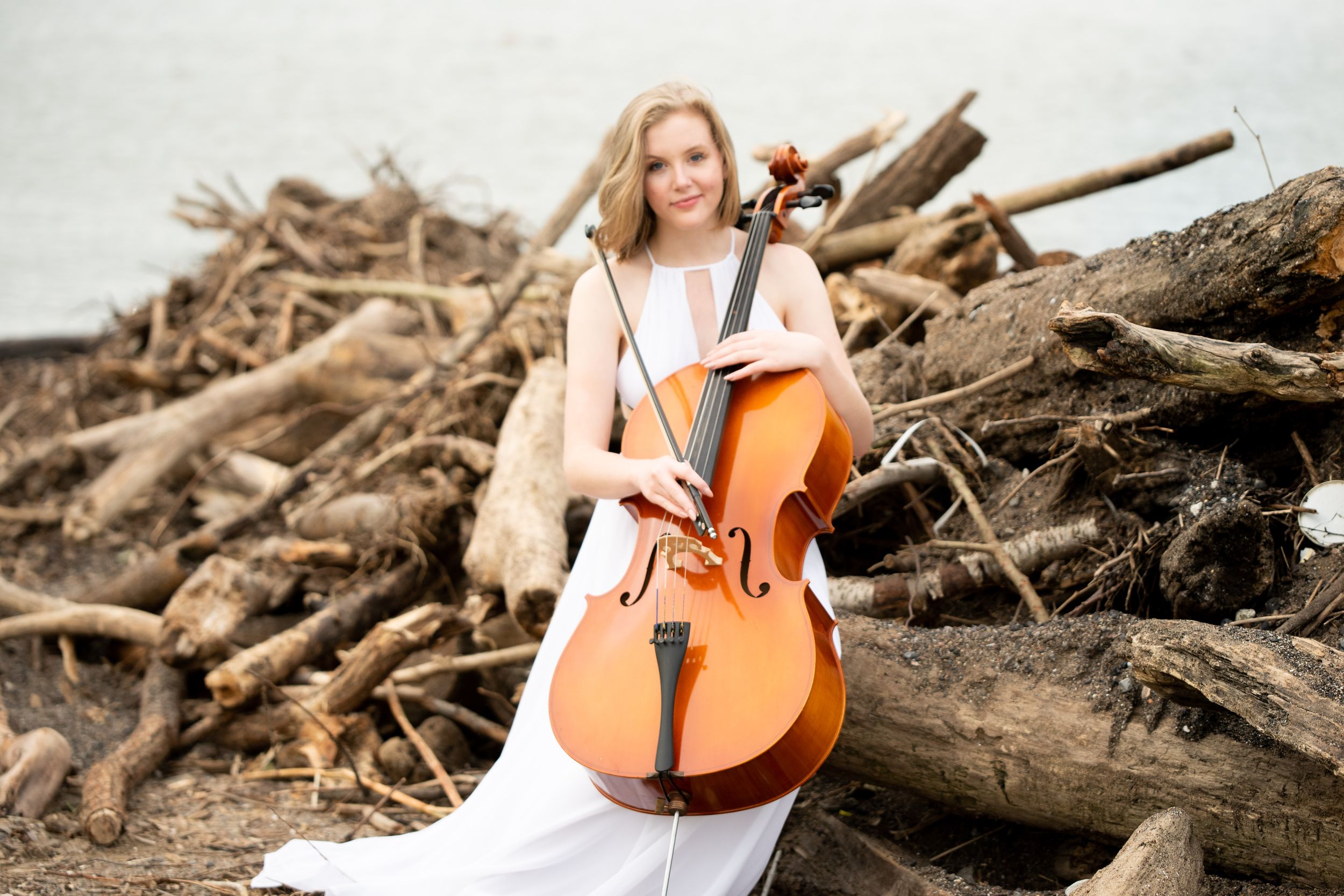 senior girl with cello on the shore of Lake Erie