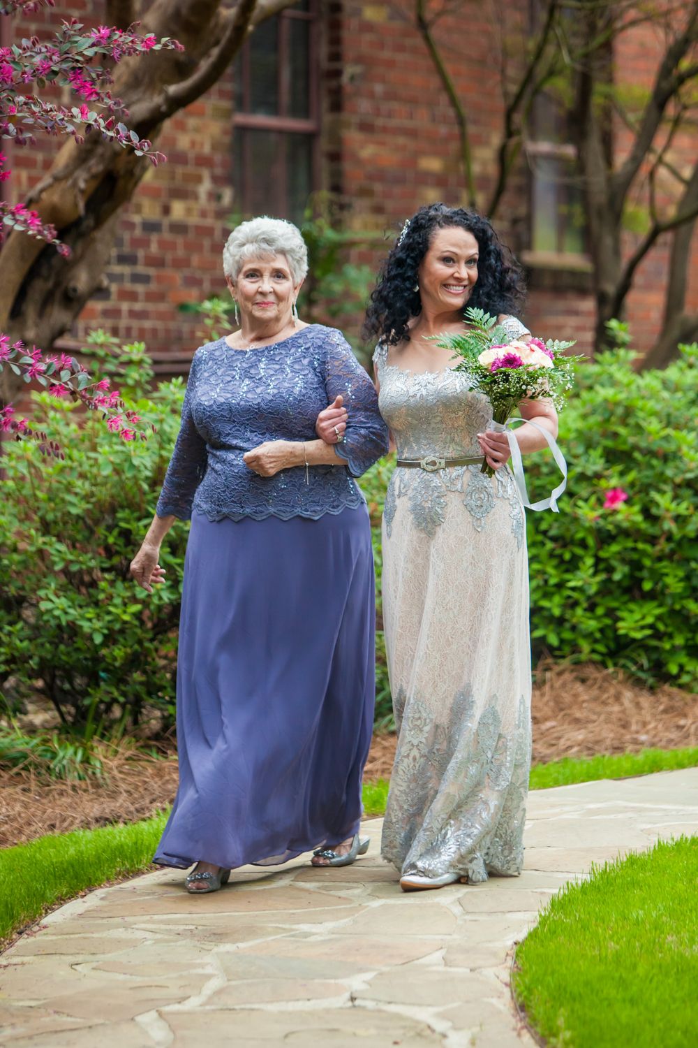 Bride is walked down the aisle by her mother during a wedding ceremony at Senate's End in Columbia, sC
